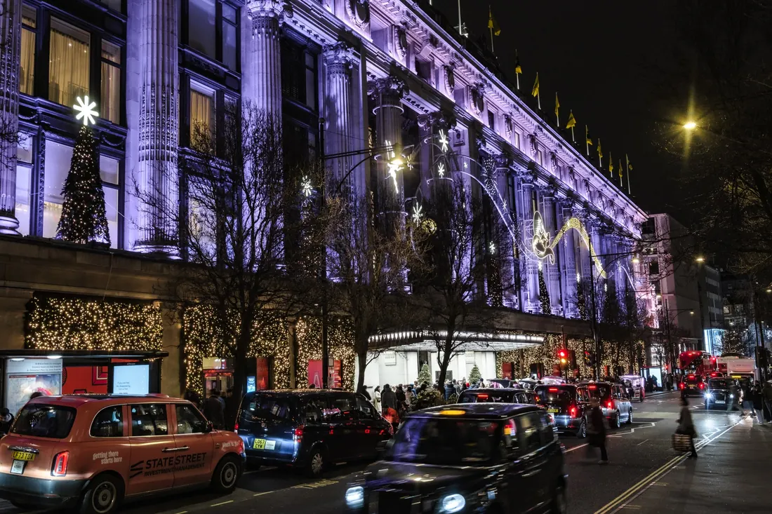 Black cabs outside Selfridges at night