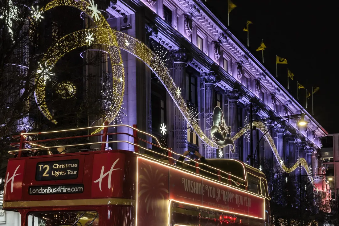 A red bus on the Christmas lights tour along Oxford Street