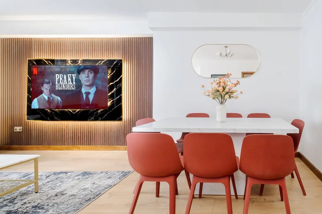 Dining table for six below the TV wall