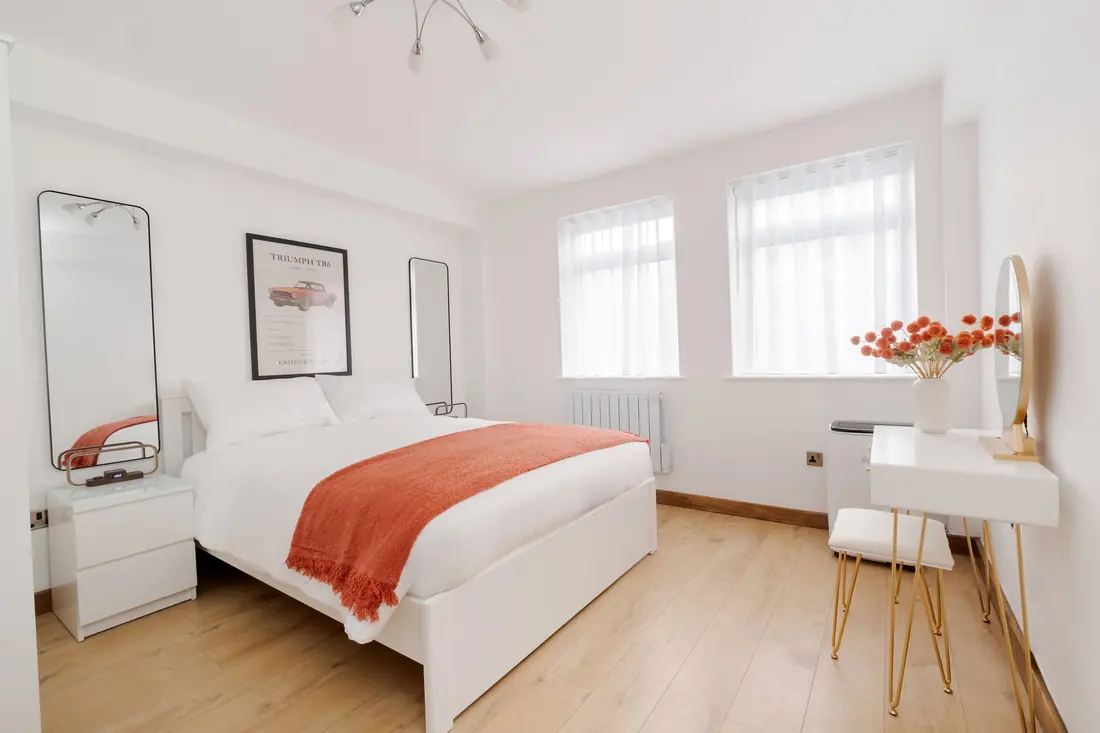 King bedroom with a classic car print and dressing table